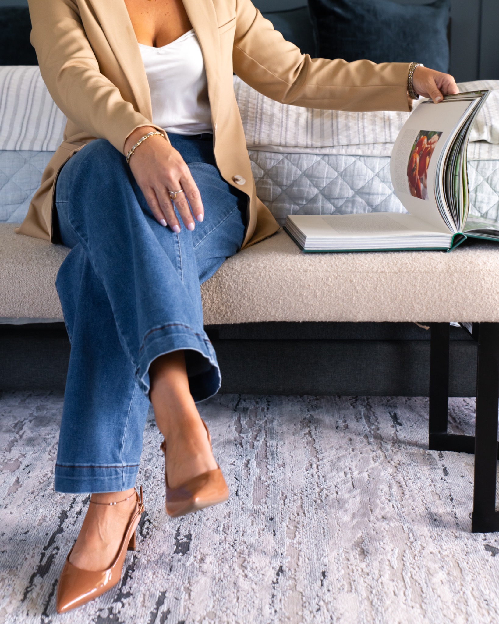 Kimberly seated with an open design book